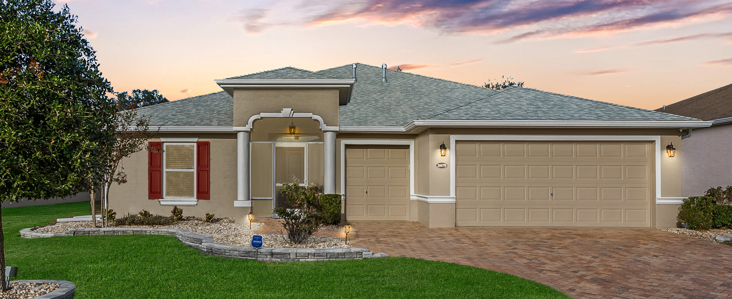 Open living room with sliding glass doors opening to a screened lanai with golf course views.