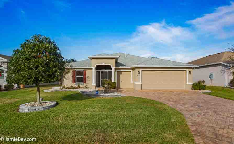 Front view of a single-story home with manicured landscaping in Arlington Ridge.