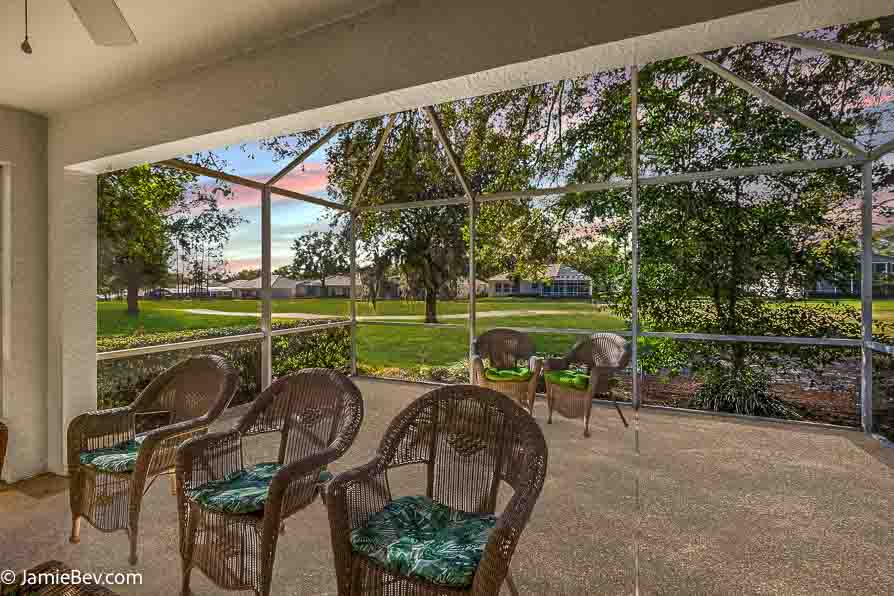 Screened patio overlooking a lush golf course.
