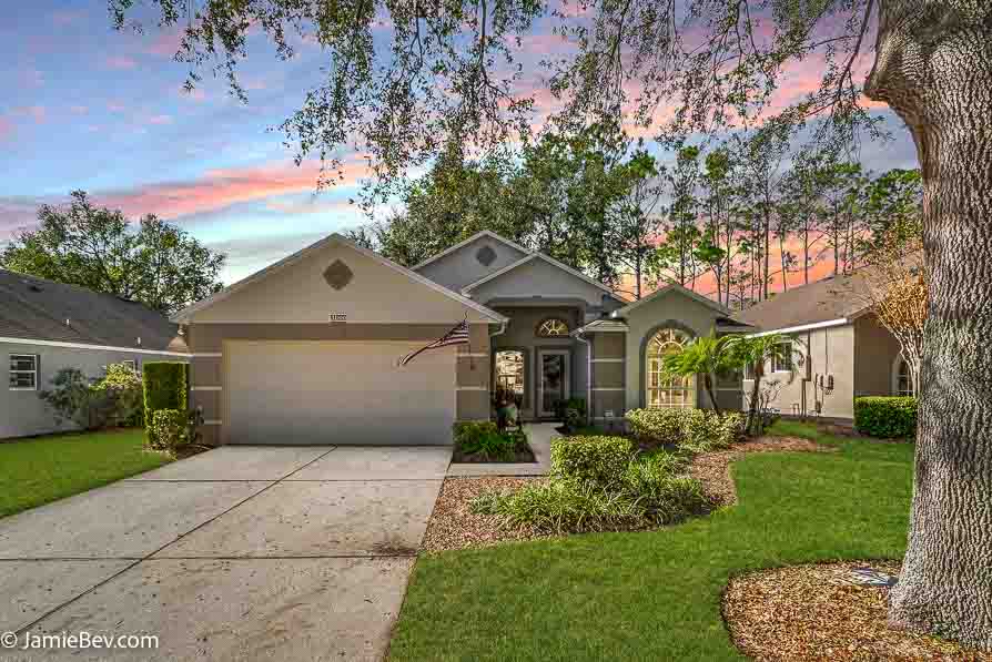 Front view of a home with a pristine exterior in a gated 55+ community.