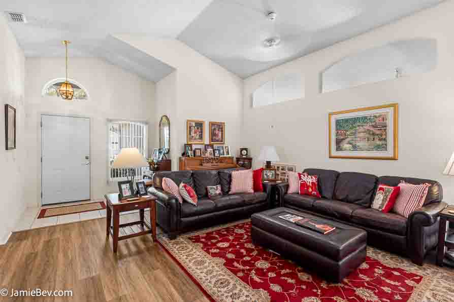 Spacious great room with vinyl plank flooring and large windows.