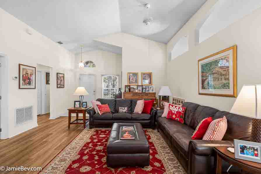 Spacious great room with vinyl plank flooring and large windows.