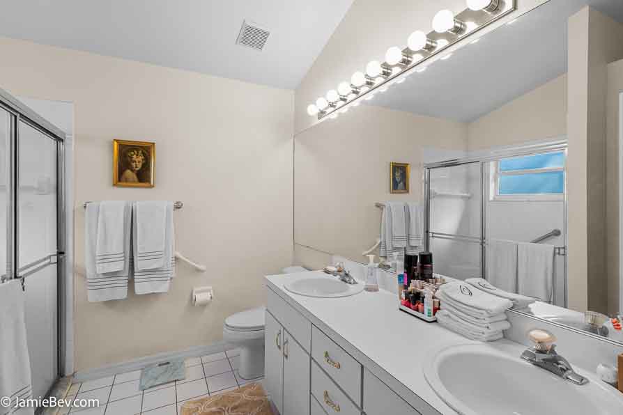 Full bathroom with a vanity, large mirror, and modern fixtures.