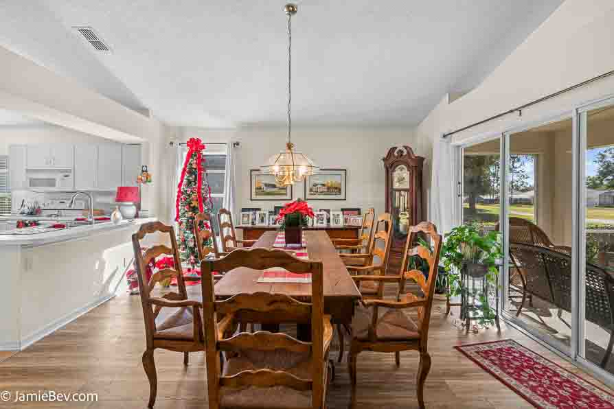 Dining room with a large table, chairs, and lots of natural light.