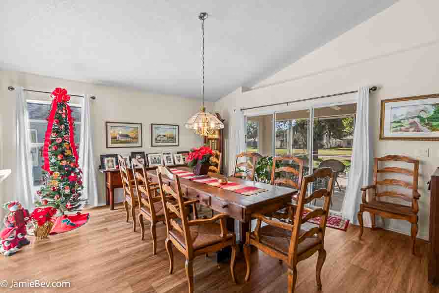 Dining room with a large table, chairs, and lots of natural light.
