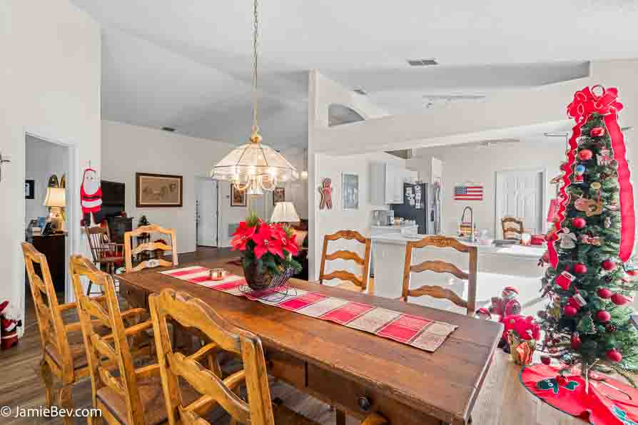 Dining room with a large table, chairs, and lots of natural light.