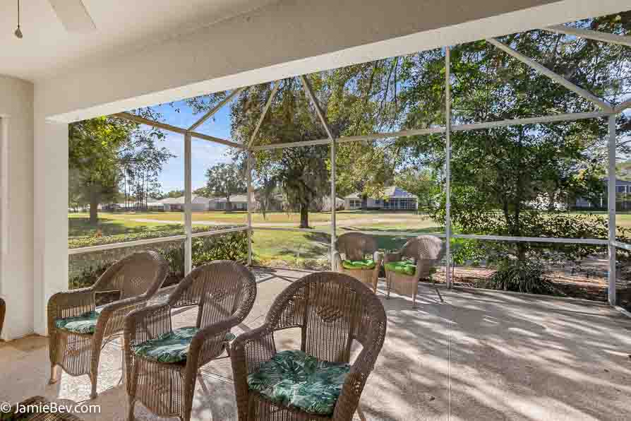 Screened patio overlooking the lush Kings Ridge golf course.
