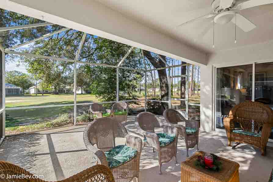 Screened patio overlooking the lush Kings Ridge golf course.