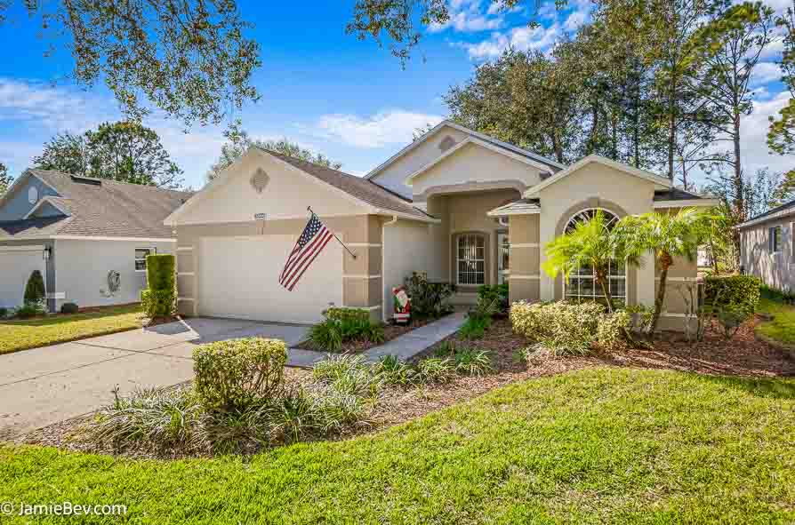 Front view of a home with a pristine exterior in a gated 55+ Clermont Florida community.