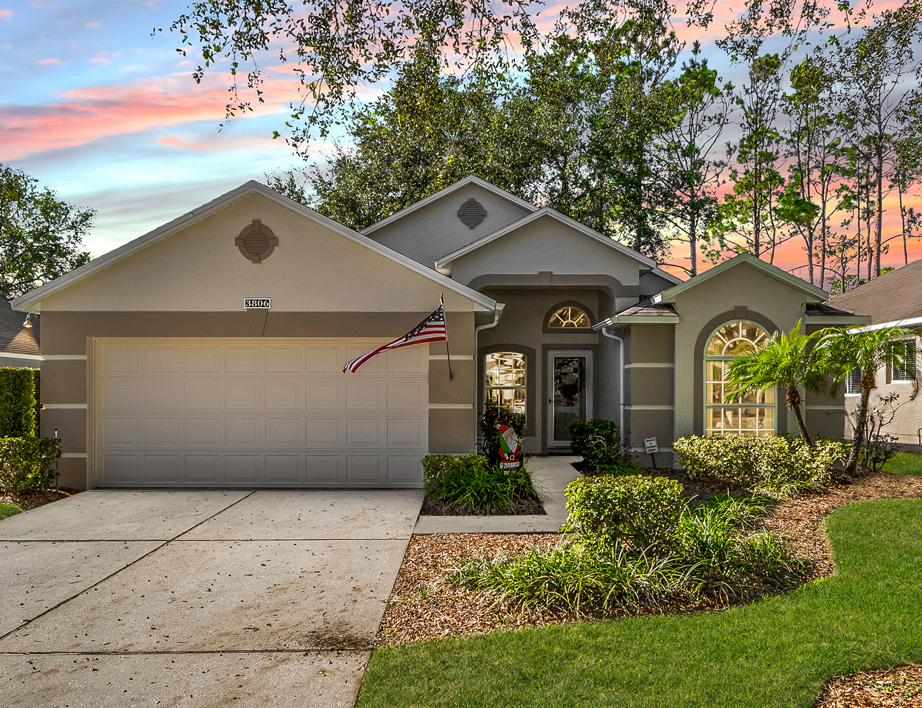Front view of a home with a pristine exterior in a gated 55+ community.