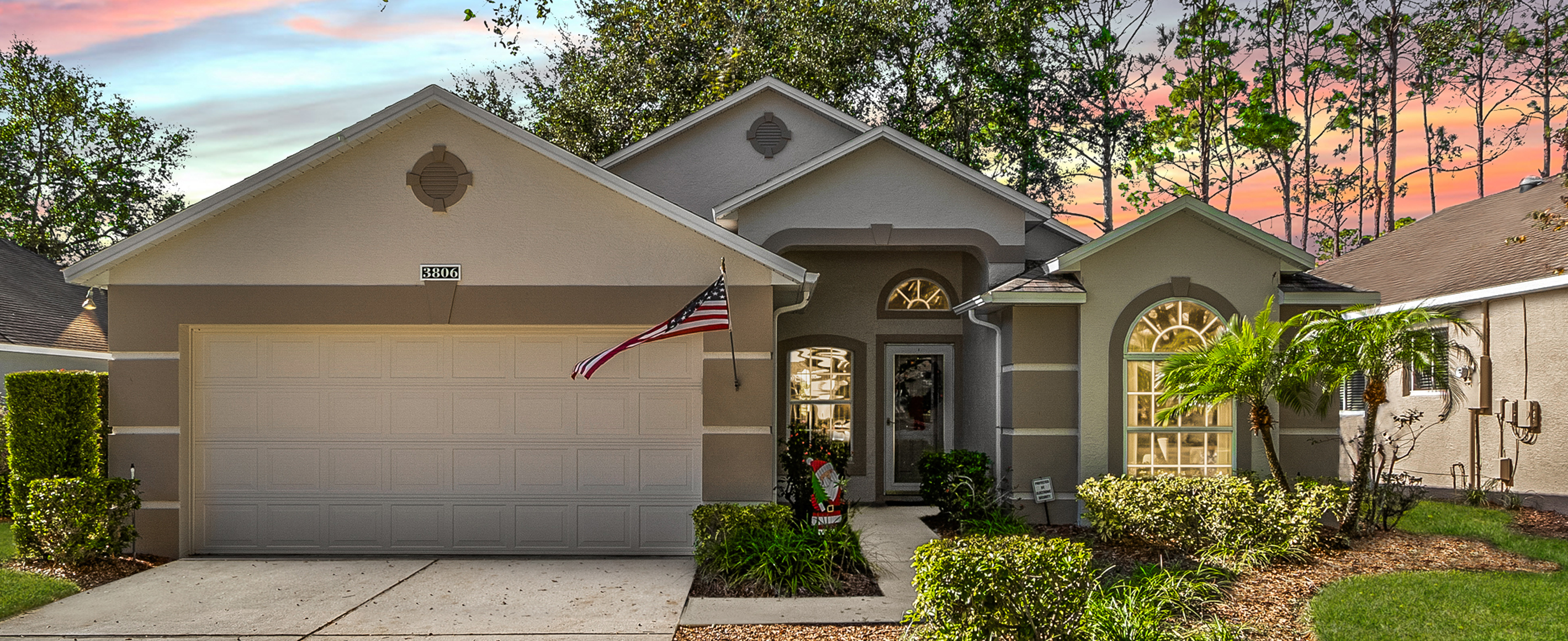 Front view of a home with a pristine exterior in a gated 55+ community.