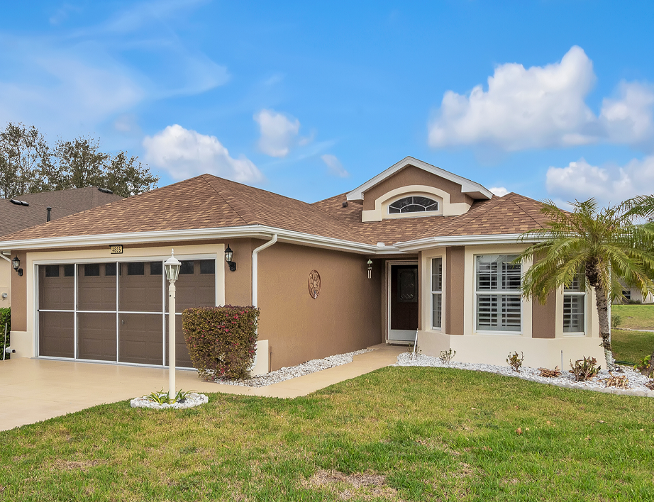 Bright open floor plan with large windows, allowing natural light to fill the living room with scenic golf course views.