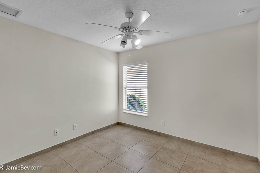Bright open floor plan with large windows, allowing natural light to fill the living room with scenic golf course views.
