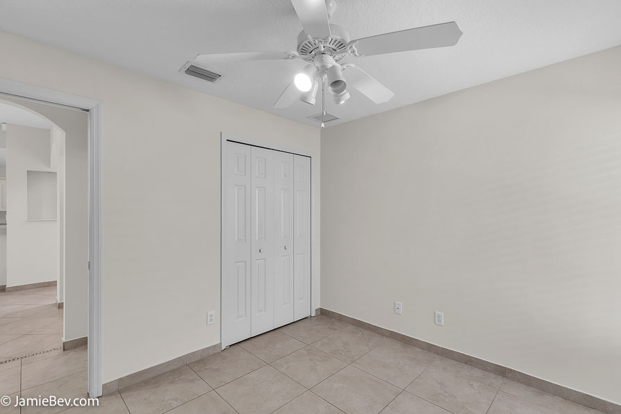 Bright open floor plan with large windows, allowing natural light to fill the living room with scenic golf course views.
