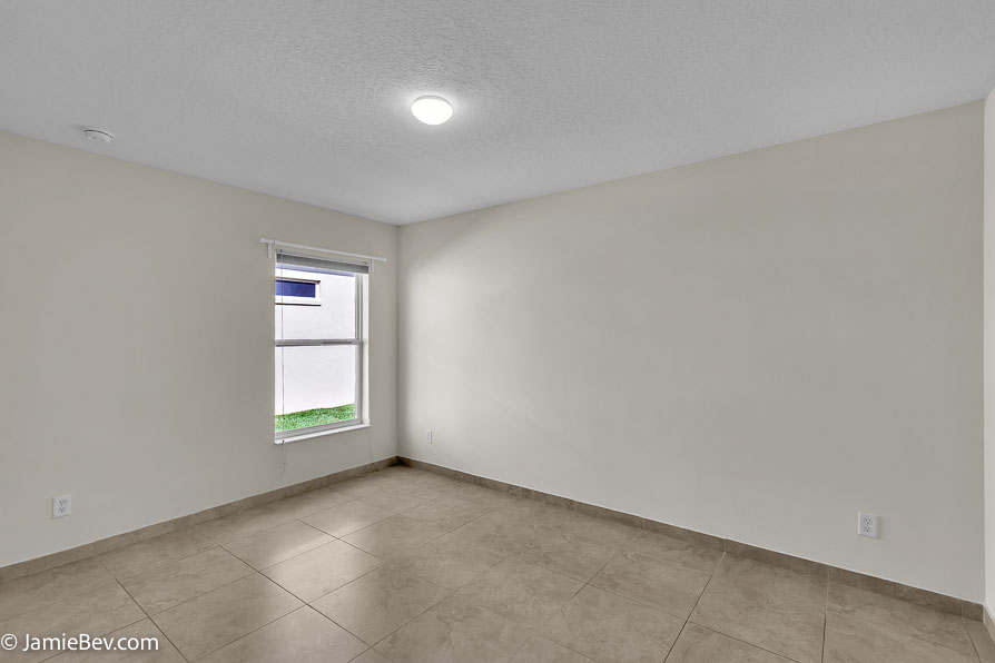 Bright open floor plan with large windows, allowing natural light to fill the living room with scenic golf course views.