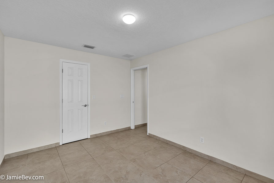Bright open floor plan with large windows, allowing natural light to fill the living room with scenic golf course views.