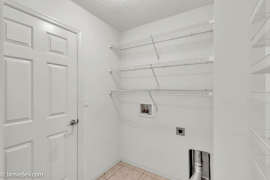 Bright open floor plan with large windows, allowing natural light to fill the living room with scenic golf course views.