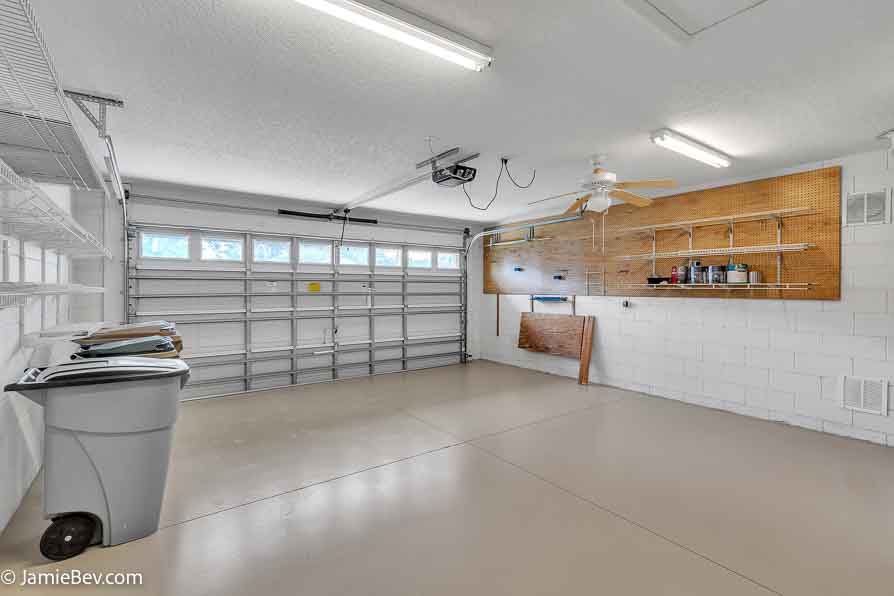 Bright open floor plan with large windows, allowing natural light to fill the living room with scenic golf course views.