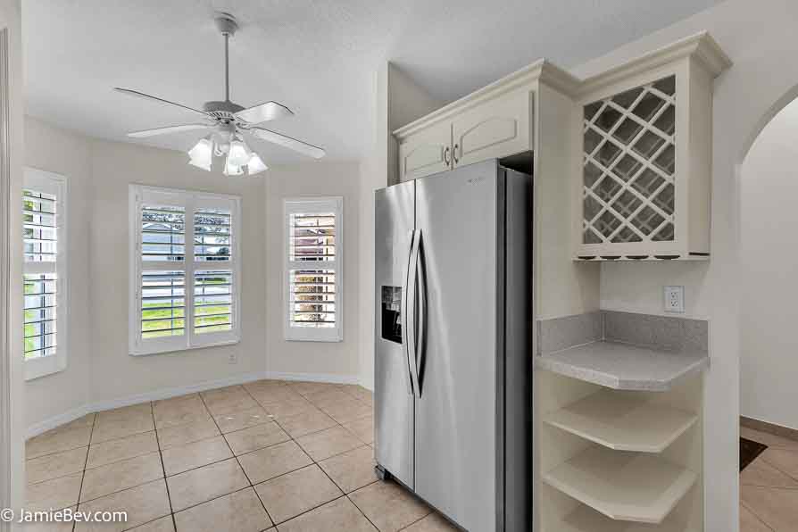 Kitchen with stainless steel appliances, a spacious countertop, and a cozy breakfast nook with bay windows.