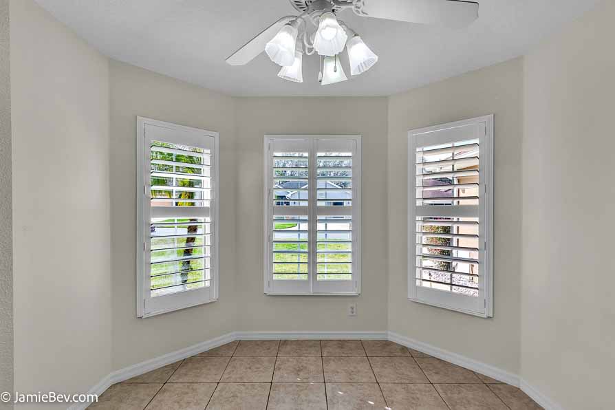 Kitchen with stainless steel appliances, a spacious countertop, and a cozy breakfast nook with bay windows.