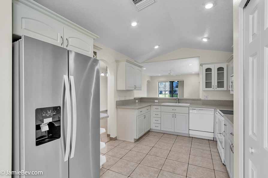 Kitchen with stainless steel appliances, a spacious countertop, and a cozy breakfast nook with bay windows.