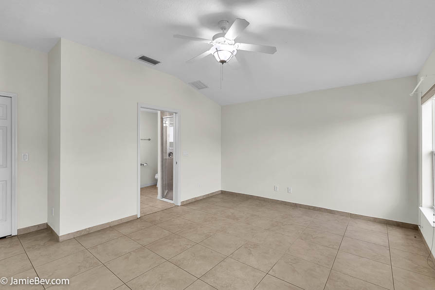 Bright open floor plan with large windows, allowing natural light to fill the living room with scenic golf course views.