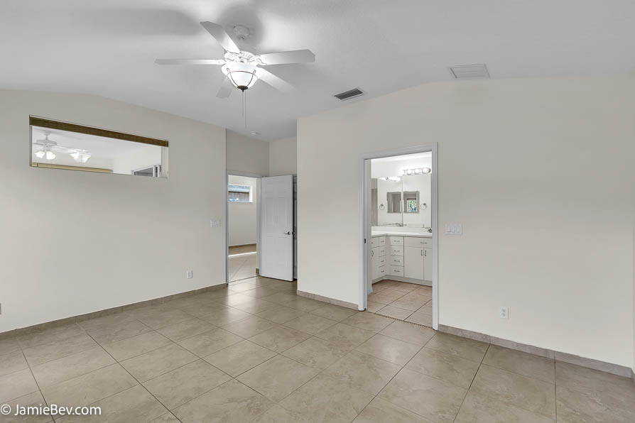 Bright open floor plan with large windows, allowing natural light to fill the living room with scenic golf course views.
