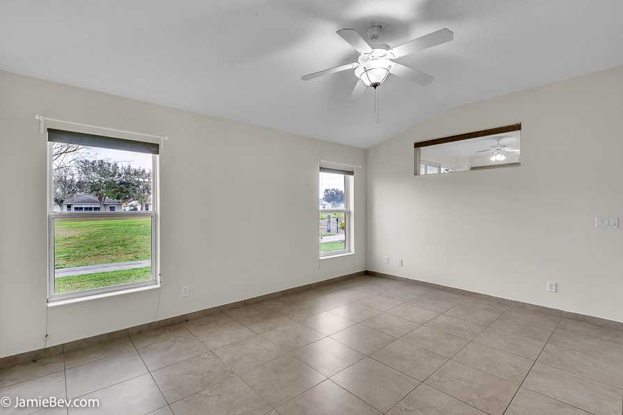 Bright open floor plan with large windows, allowing natural light to fill the living room with scenic golf course views.