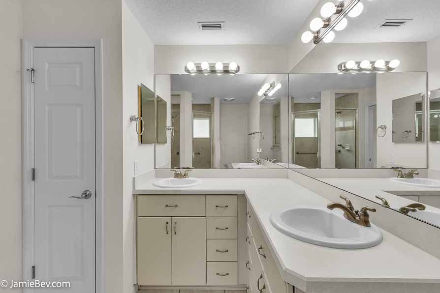 Bright open floor plan with large windows, allowing natural light to fill the living room with scenic golf course views.