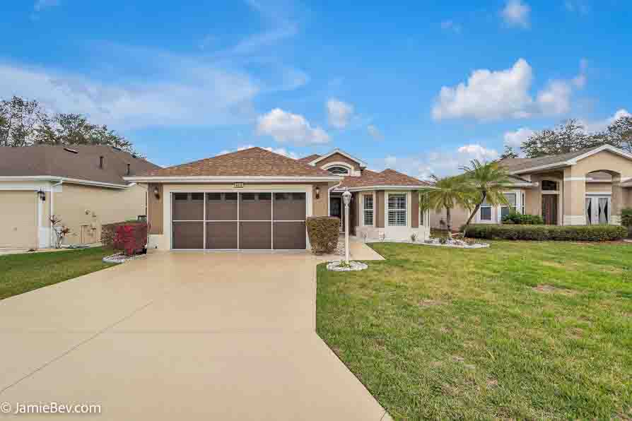 Bright open floor plan with large windows, allowing natural light to fill the living room with scenic golf course views.