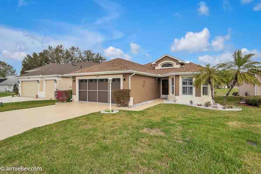 Bright open floor plan with large windows, allowing natural light to fill the living room with scenic golf course views.