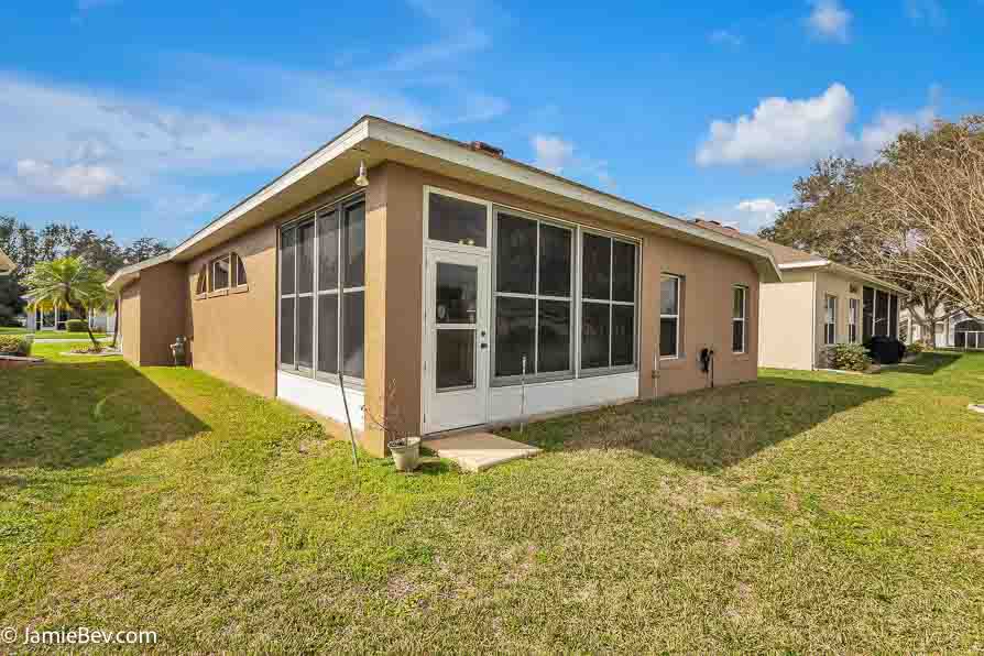 Bright open floor plan with large windows, allowing natural light to fill the living room with scenic golf course views.