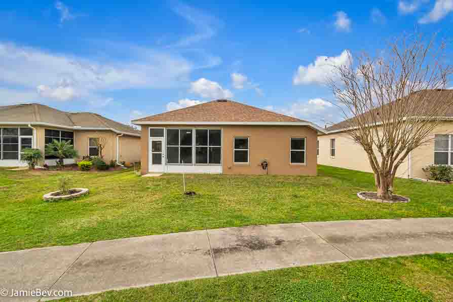 Bright open floor plan with large windows, allowing natural light to fill the living room with scenic golf course views.
