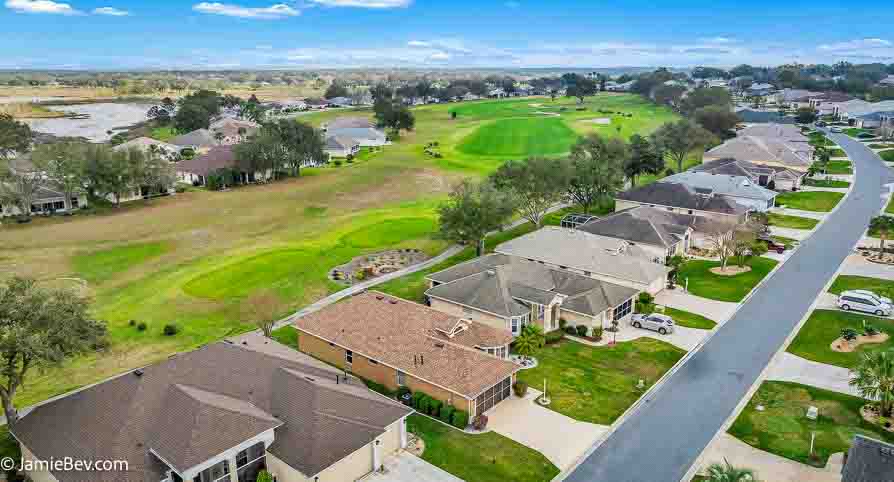 Aerial view of the Royal Highlands community, showing the golf course, lakes, and lush green spaces.