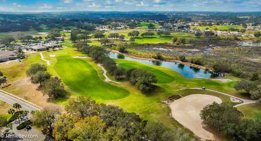 Aerial view of the Royal Highlands community, showing the golf course, lakes, and lush green spaces.
