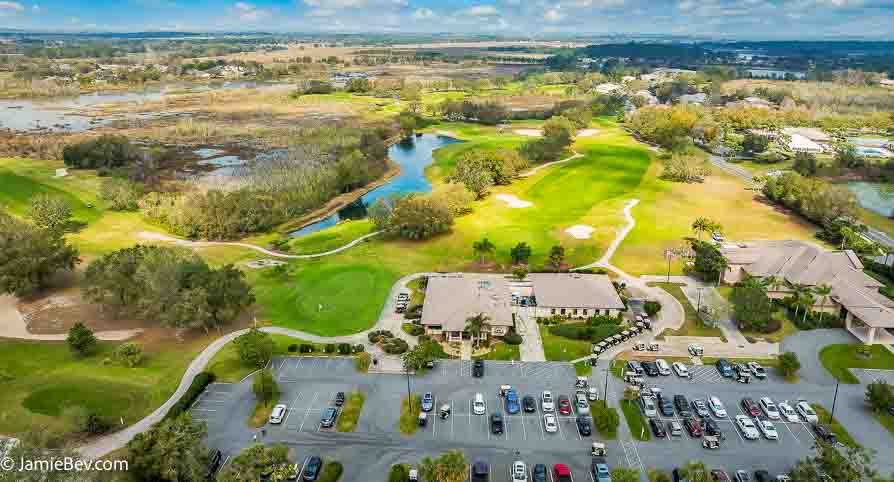 Aerial view of the Royal Highlands community, showing the golf course, lakes, and lush green spaces.