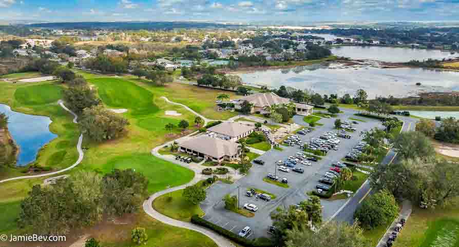Aerial view of the Royal Highlands community, showing the golf course, lakes, and lush green spaces.