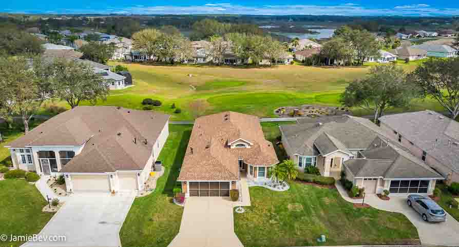 Aerial view of the Royal Highlands community, showing the golf course, lakes, and lush green spaces.