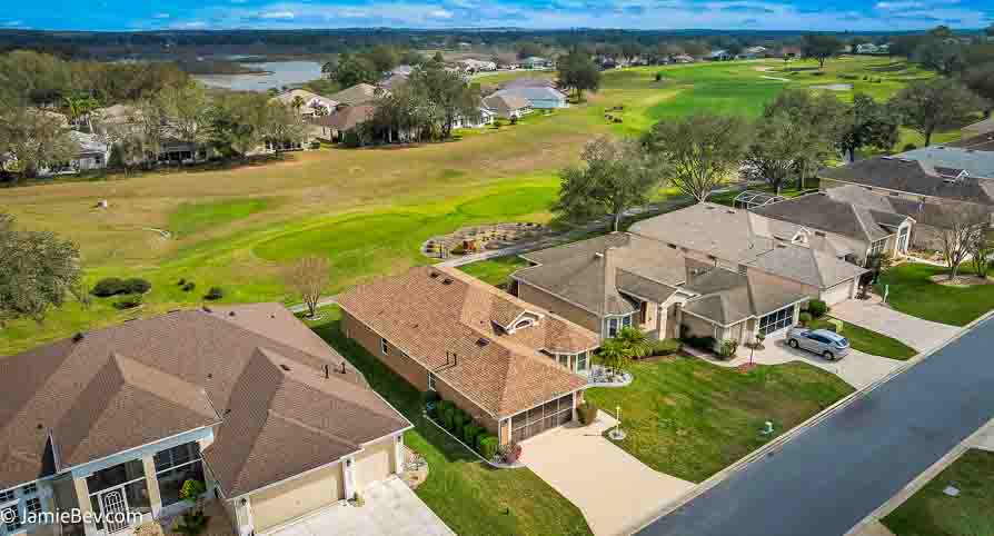 Aerial view of the Royal Highlands community, showing the golf course, lakes, and lush green spaces.
