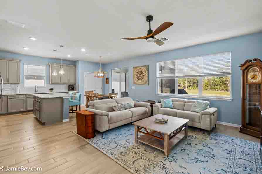 Open-concept gathering room with large windows and elegant finishes.