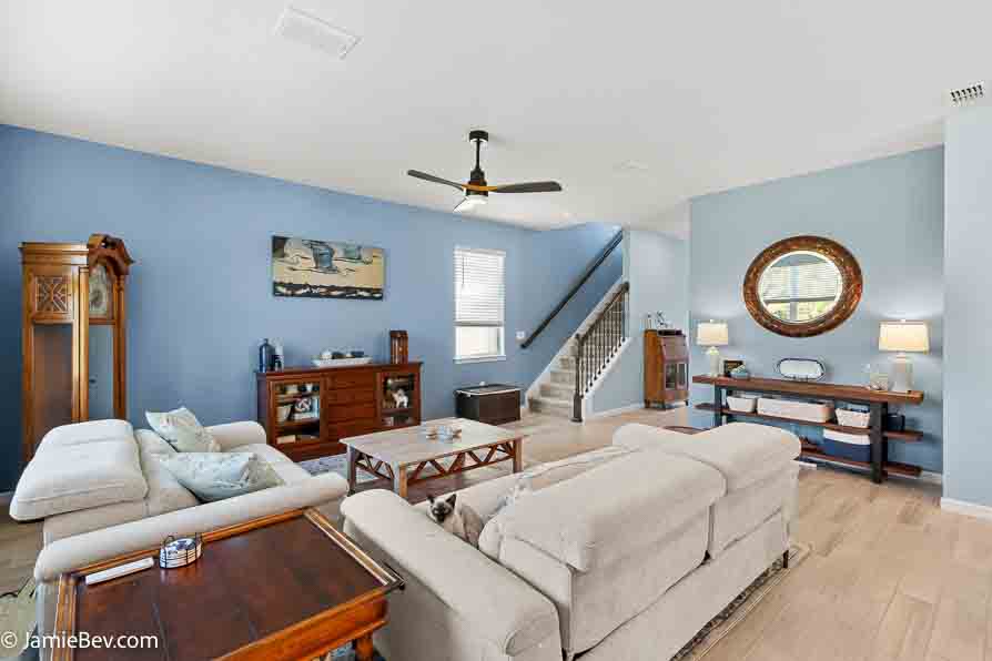 Open-concept gathering room with large windows and elegant finishes.