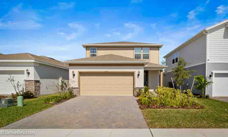 A beautifully designed home in the Serenoa Lakes community, featuring modern finishes and a spacious layout with no rear neighbors.