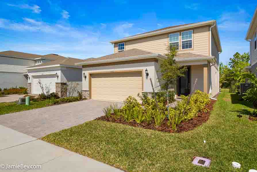 A beautifully designed home in the Serenoa Lakes community, featuring modern finishes and a spacious layout with no rear neighbors.