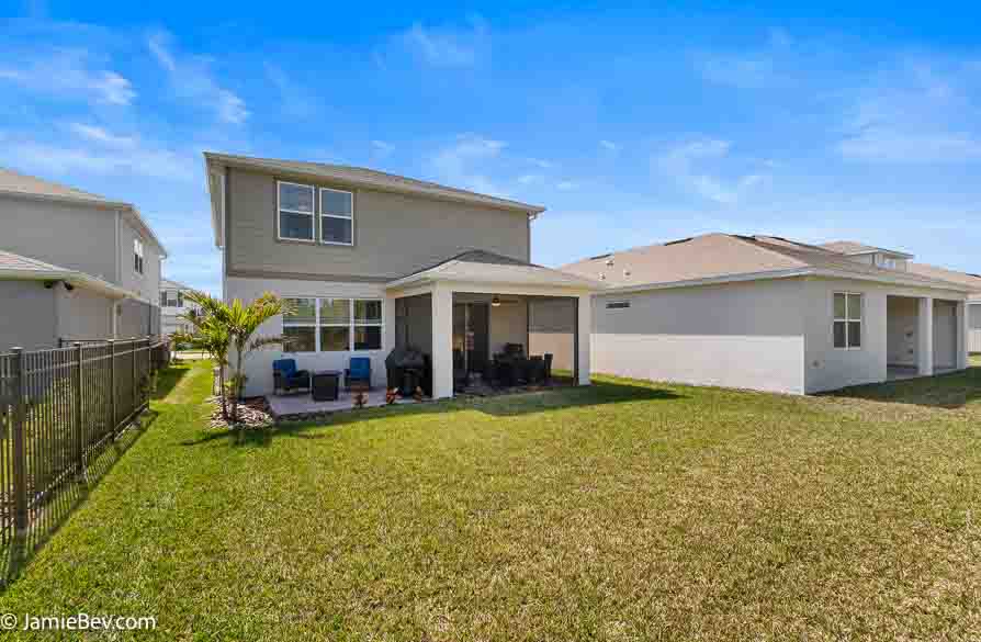 A beautifully designed home in the Serenoa Lakes community, featuring modern finishes and a spacious layout with no rear neighbors.