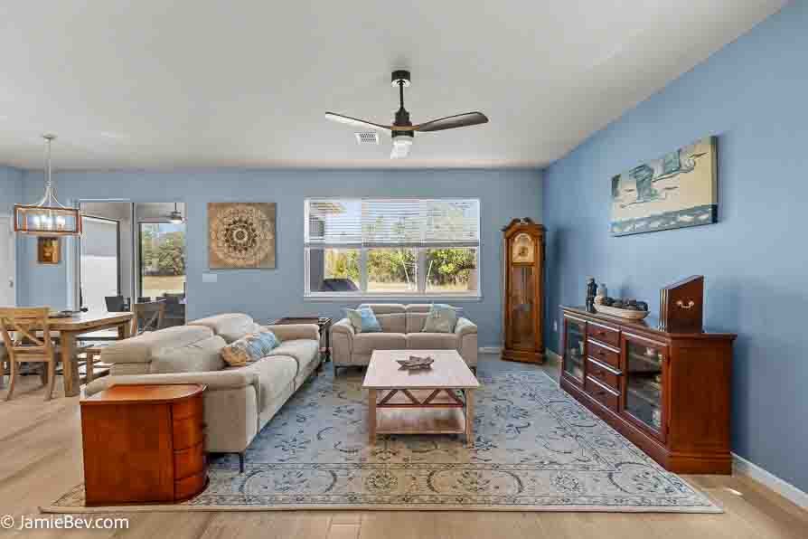 Open-concept gathering room with large windows and elegant finishes.